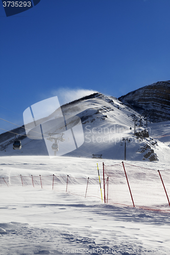Image of Gondola lift on ski resort at windy sun day