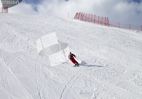 Image of Skier on ski slope at sun day