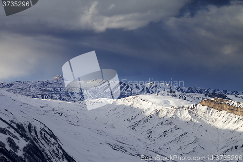 Image of Winter mountains at evening and storm clouds