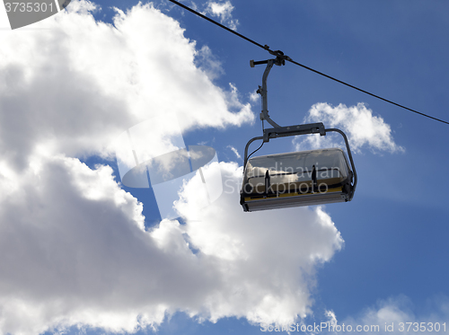 Image of Chair-lift and sunlight sky