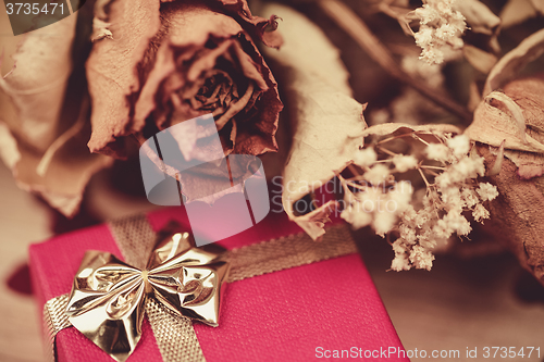 Image of bouquet of dried roses and red box, valentine