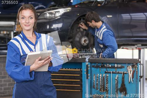 Image of female mechanic in car garage