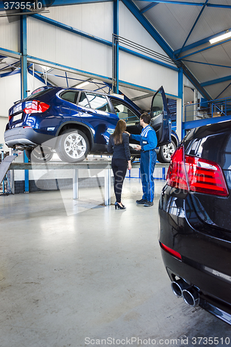 Image of mechanic and customer in garage