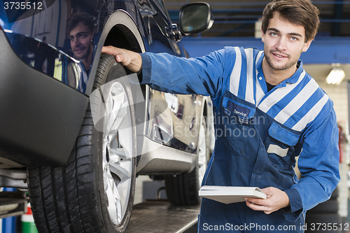 Image of technician inspection a car 