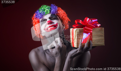 Image of scary clown makeup and with a terrible gift