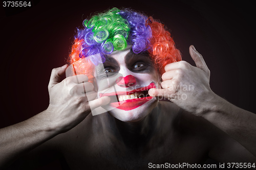 Image of Evil Spooky Clown Portrait on dark background. expressive man