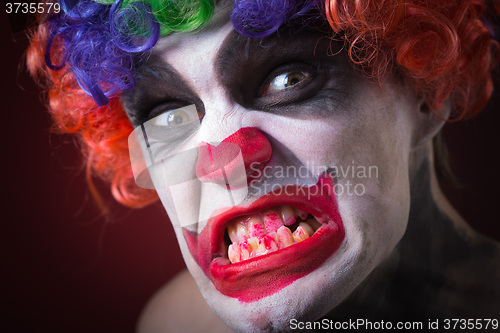 Image of Evil Spooky Clown Portrait on dark background. expressive man