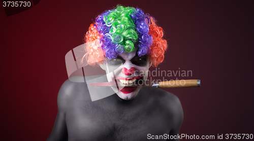 Image of crazy clown  with a knife