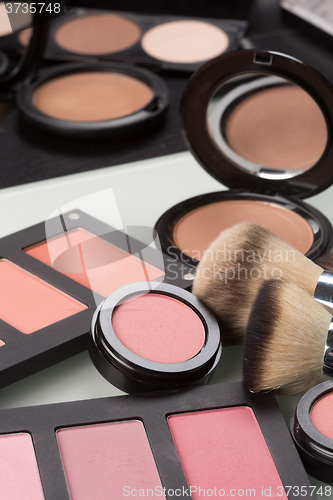 Image of makeup cosmetics. compact powder, mineral foundation and makeup brushes