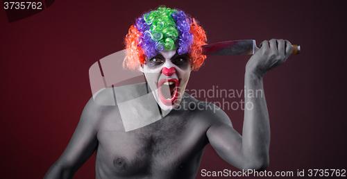 Image of crazy clown  with a knife