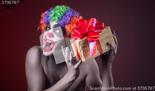 Image of scary clown makeup and with a terrible gift