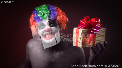 Image of scary clown makeup and with a terrible gift