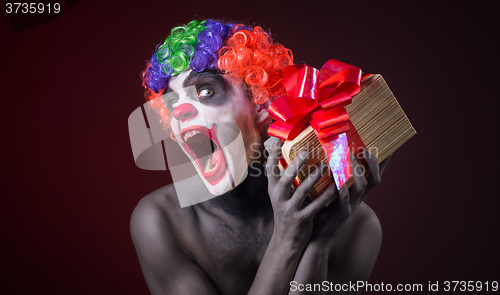 Image of scary clown makeup and with a terrible gift