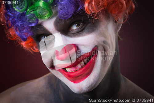 Image of Evil Spooky Clown Portrait on dark background. expressive man