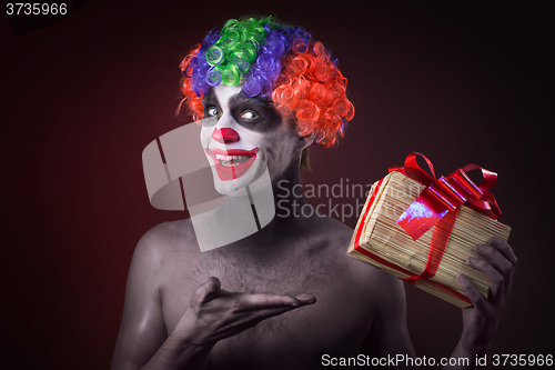 Image of scary clown makeup and with a terrible gift