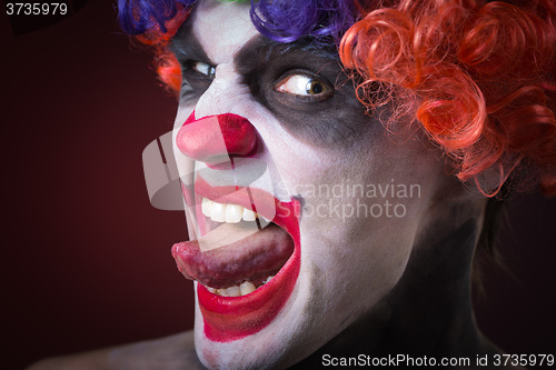 Image of Evil Spooky Clown Portrait on dark background. expressive man