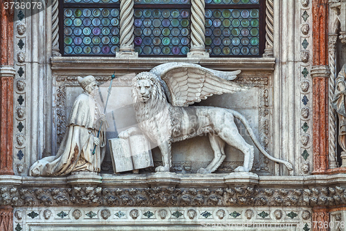 Image of Winged lion on facade of the bell tower at San Marco square in V