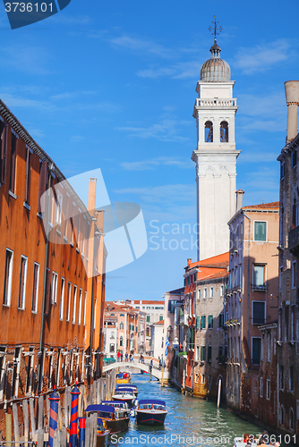 Image of Narrow canal with bridge in Venice