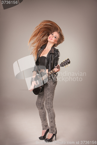 Image of Beautiful girl playing guitar