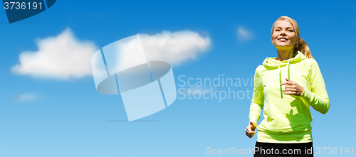 Image of woman jogging over blue sky and clouds background