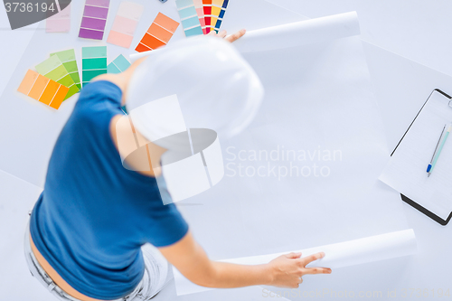 Image of woman with color samples and blueprint