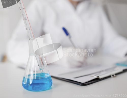 Image of close up of scientist making test in laboratory