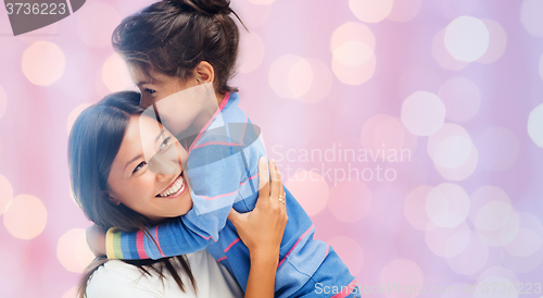 Image of happy mother and daughter hugging