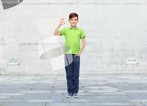 Image of happy boy in white t-shirt showing ok hand sign