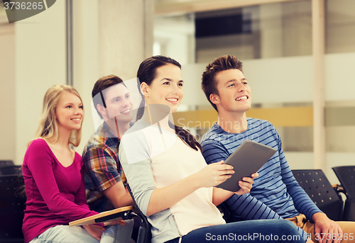 Image of group of smiling students with tablet pc