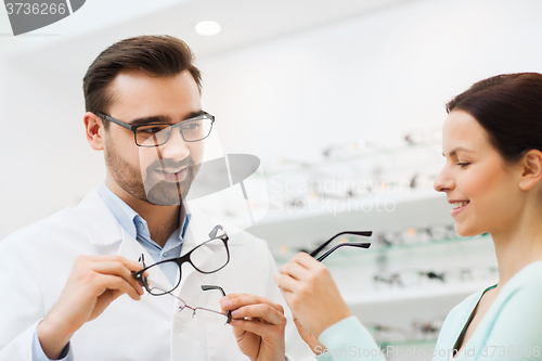 Image of woman and optician showing glasses at optics store