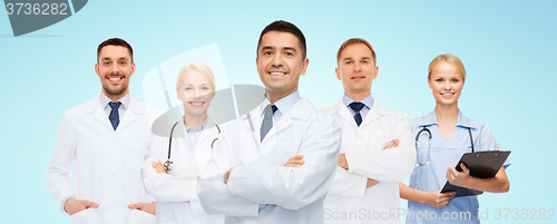 Image of group of smiling doctors with clipboard