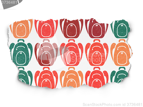Image of Education concept: Backpack icons on Torn Paper background