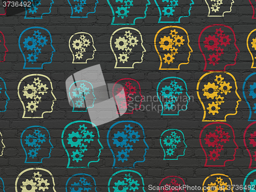 Image of Information concept: Head With Gears icons on wall background