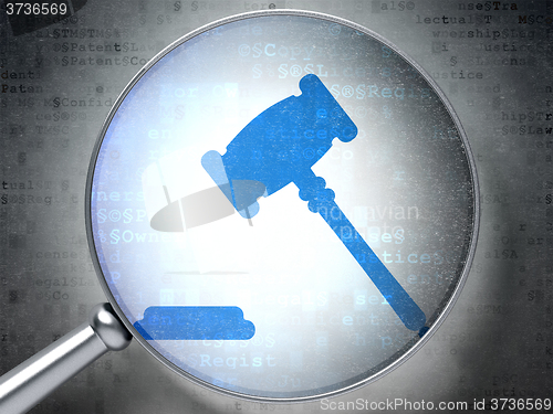 Image of Law concept: Gavel with optical glass on digital background