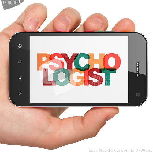 Image of Medicine concept: Hand Holding Smartphone with Psychologist on  display