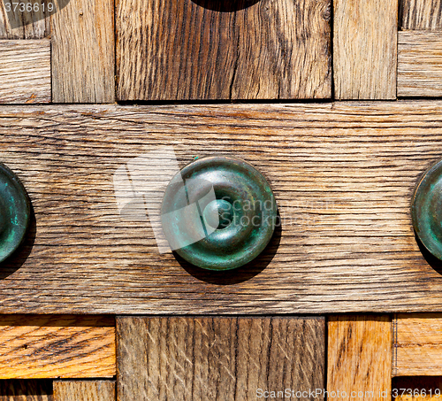 Image of in london antique brown door  rusty  brass nail and light