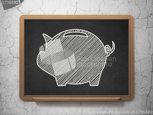 Image of Currency concept: Money Box on chalkboard background