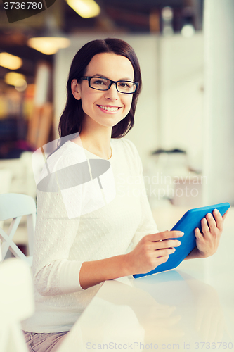 Image of smiling woman with tablet pc at cafe