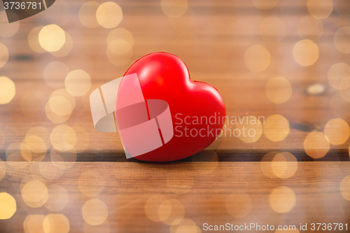 Image of close up of red heart decoration on wood