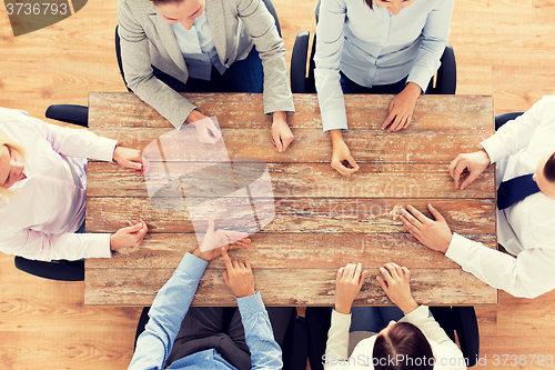 Image of close up of business team sitting at table