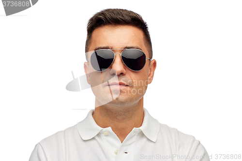 Image of face of man in polo t-shirt and sunglasses