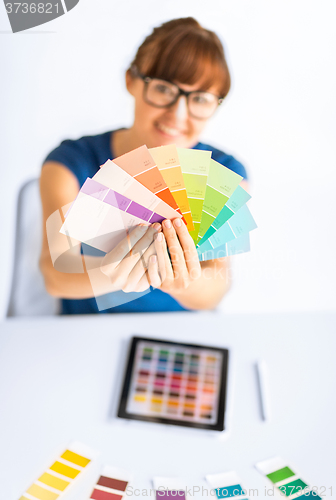 Image of woman showing pantone color samples