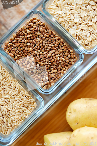 Image of close up of grain in glass bowls on wooden table