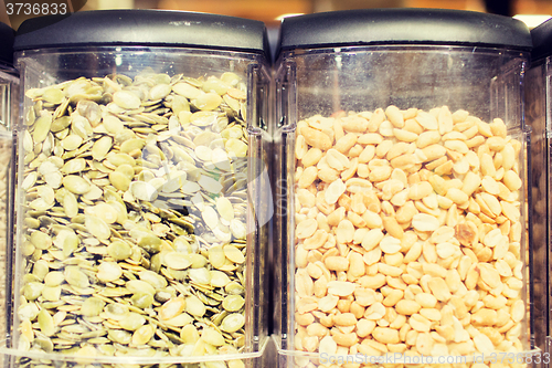 Image of jars of peanuts and pumpkin seeds at grocery store