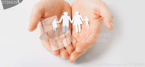 Image of man hands with paper man family