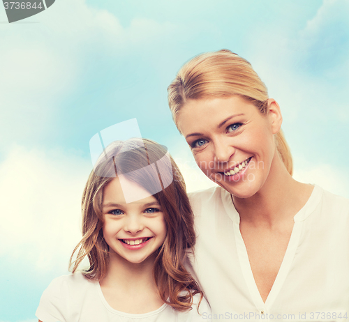 Image of smiling mother and little girl