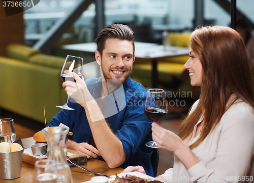 Image of couple dining and drinking wine at restaurant