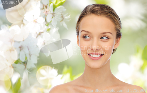 Image of smiling young woman face and shoulders