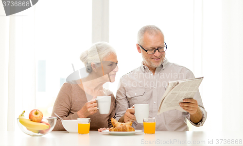 Image of happy senior couple having breakfast at home