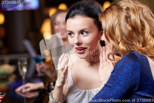 Image of happy women with drinks at night club